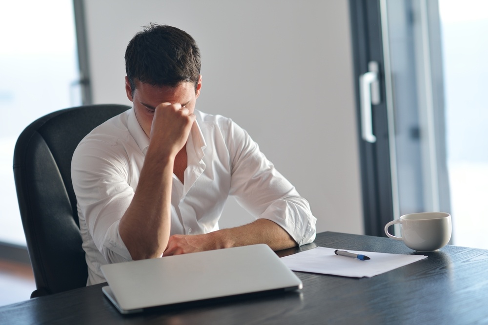 frustrated with problems young business man working on laptop computer at home.jpeg